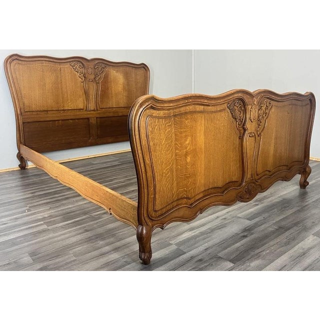 This elegant Vintage French Louis double bed features beautifully shaped oak panels with refined carved detailing to both...