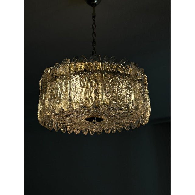 The lamp consists of a metal frame and a large crystal plate, as well as 12 smaller glass crystal elements around it. It...