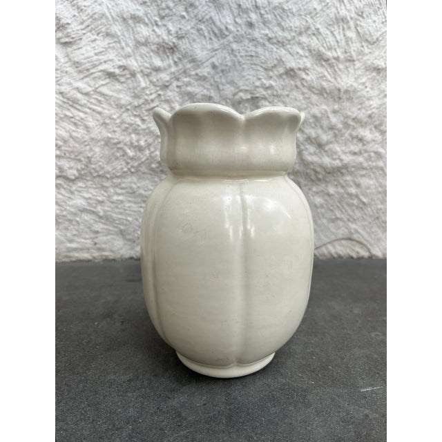 Set of two matte white glaze art deco pottery vases. The taller one is attributed to Camark with the remnants of the...