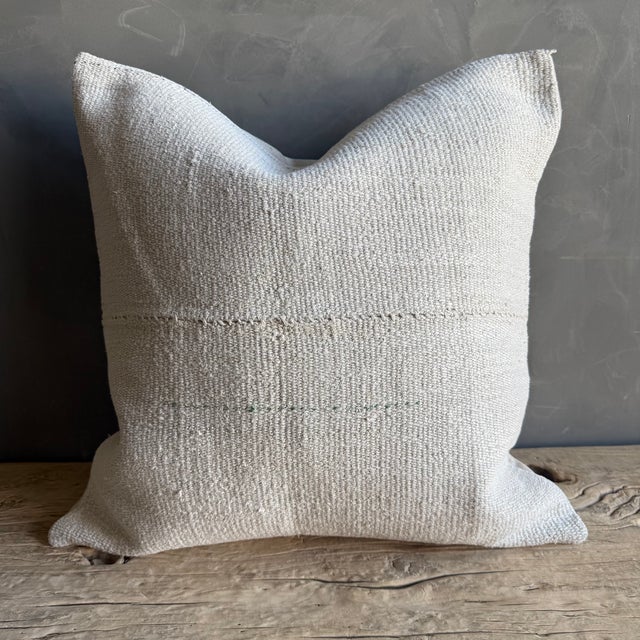 Creamy white hemp rug pillow with original seams. Soft hand, linen blend backing with zipper closure. Spot cleaning is...