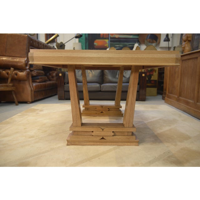 A superb oak dining table with a powerful, architectural design, typical of French production from the 1940s in the...