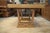 A superb oak dining table with a powerful, architectural design, typical of French production from the 1940s in the...