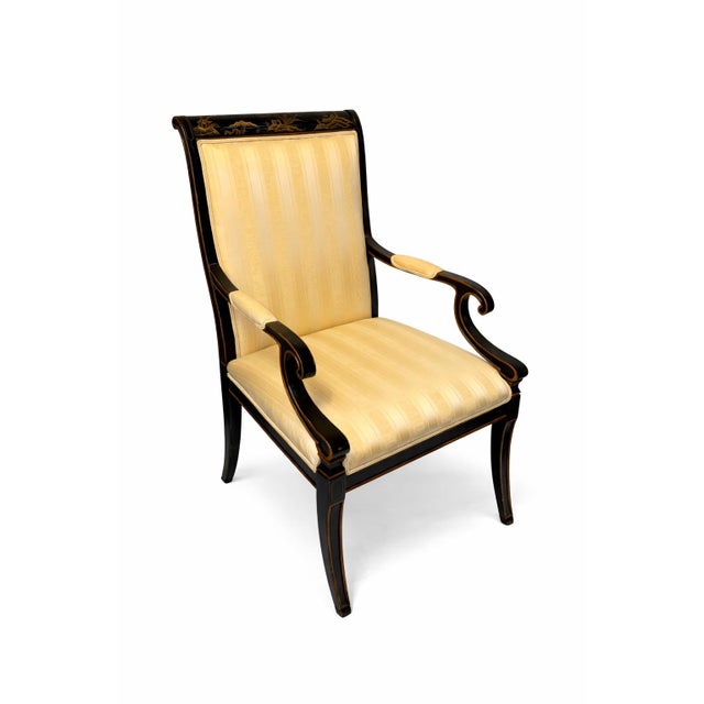 Elegant set of two Regency-style armchairs by Karges, featuring refined ebonized wood frames with graceful saber legs and...