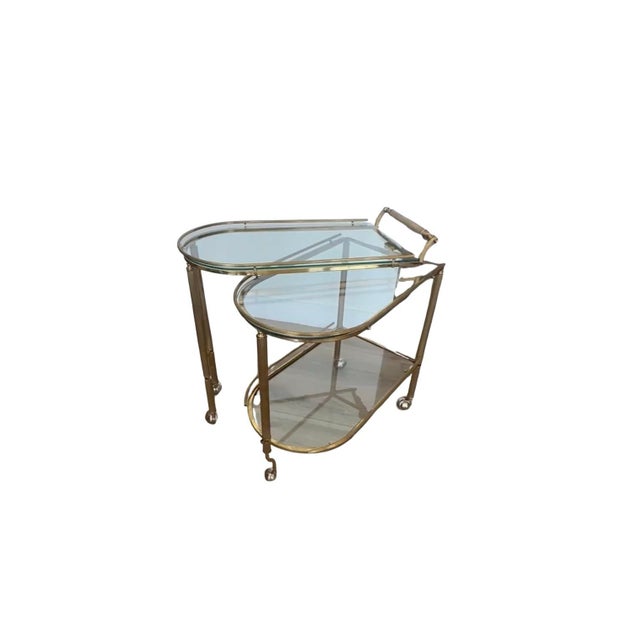 This Hollywood Regency swivel bar cart exudes glamor and classic design. It features three glass tops and a roll out...