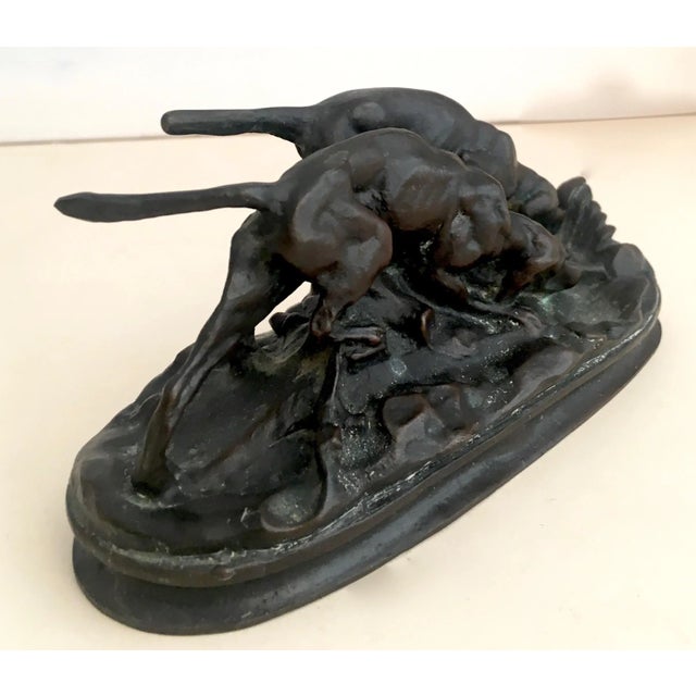A small but important and impressive bronze sculpture of hunting Bloodhounds by renowned artist Bayre, signed.