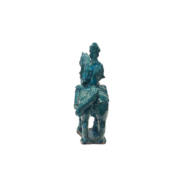 The Vintage Distressed Dark Green Glaze Ceramic Soldier Riding Horse Figure exudes an aura of antiquity and regality,...