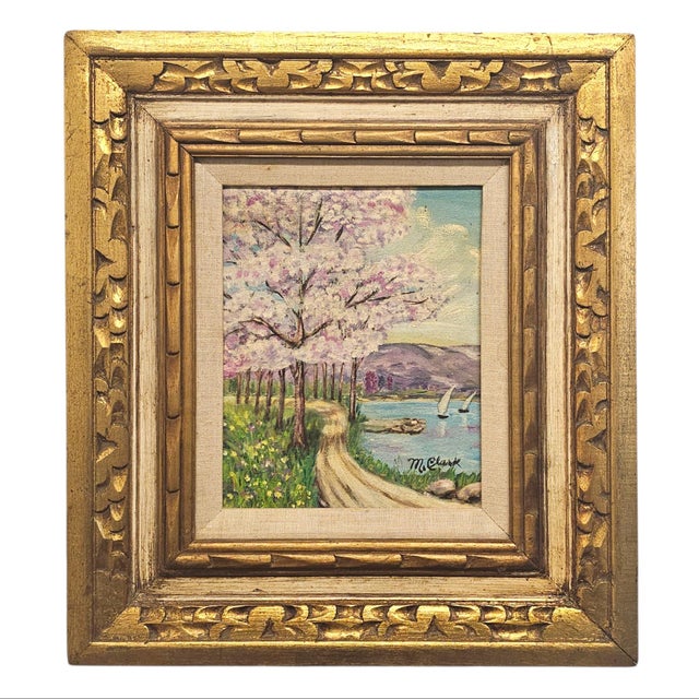 This matched pair of original oil paintings signed M. Clark depicts tranquil coastal landscapes framed by flowering cherry...