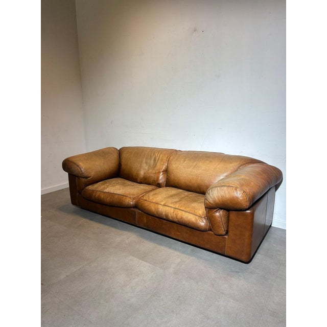 Upgrade your space with this stunning vintage cognac leather sofa , a timeless piece that blends comfort and character....