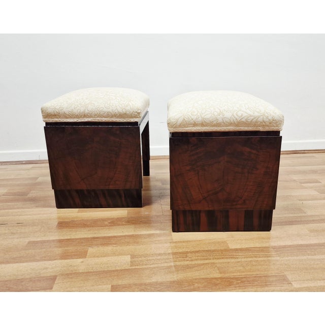 They feature a solid architectural structure with walnut panels featuring prominent grain, often combined with burl...