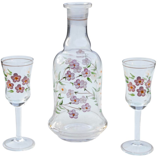 Beautiful set of three midcentury handblown stemmed glasses and matching decanter. Exhibiting an elaborate hand-painted...
