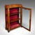 This is an antique pier cabinet. An English, walnut and ormolu glazed display or bookcase, dating to the Victorian period,...