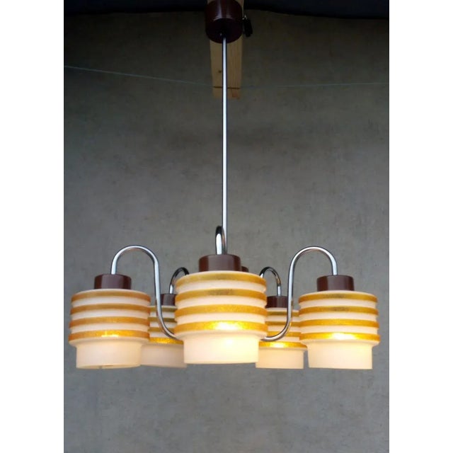 Beautiful authentic retro vintage chandelier designed for lidokov by jozef hurka. It has a chrome brown holder, yellow-...