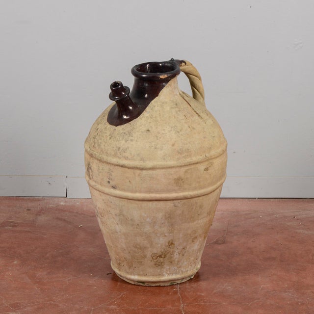 This large vintage amphora, once used to store wine or oil, is a magnificent example of italian rural craftsmanship....