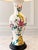 Beautiful vintage table lamp featuring a glossy white ceramic body decorated with delicate pink floral blossoms and green...