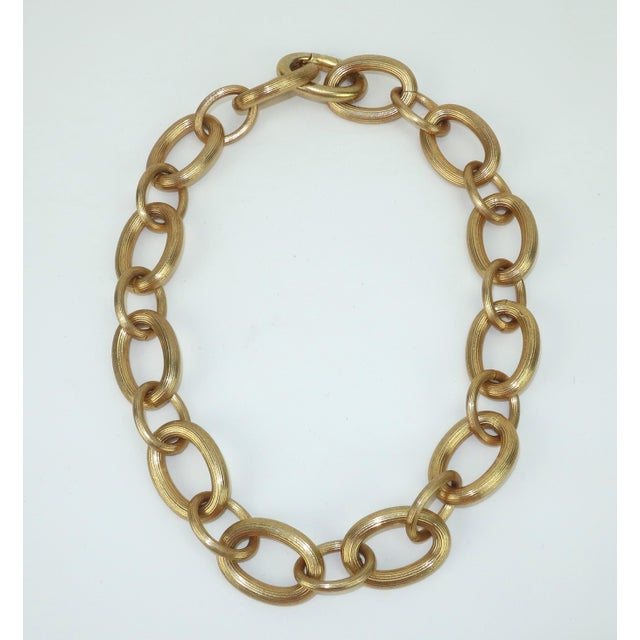 Chunky monkey! Fabulous fluted gold link chain necklace by Ralph Lauren. The chunky look is created with oval shaped...