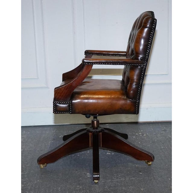Exquisite Rare Cigar Brown Leather Chesterfield Directors Swivel Office Chair. This exquisite chair features a robust...