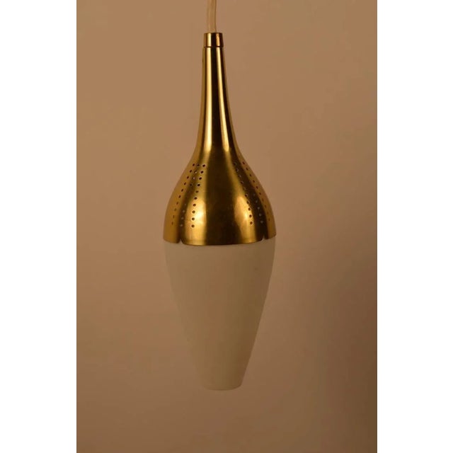 Hanging pendant light, brass top, frosted white glass bottom. Original brass canopy included. Height of fixture without...
