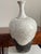 A striking 22-inch signed raku pottery vase by American ceramic artist Kerry Gonzalez, featuring an ivory crackle glaze...