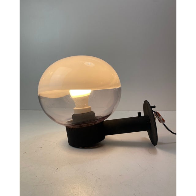Set of two sconces originally made for exterior purposes, these astonishing pieces are beautifully made. A blown clear...
