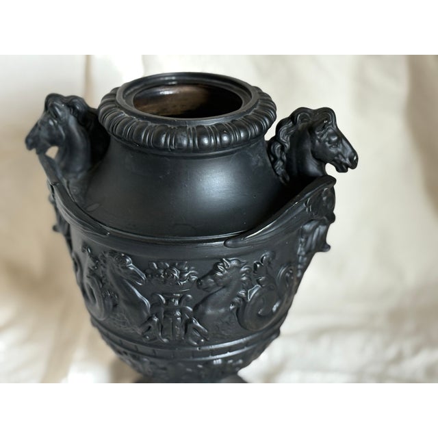 An antique Bassalt horse head urn. This Neo classical piece has decorative handles in the shape of winged horses. Its body...