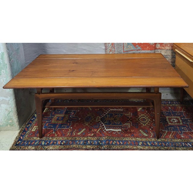 Metamorphic dining / coffee table in teak, 1960s, by Kai Kristiansen for Trioh. Beautiful wood grain. The table is...