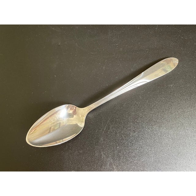 One (1) National Silver Co sterling 5⅝” Five O'Clock teaspoon in the Overture pattern. Nice condition, with light stains...