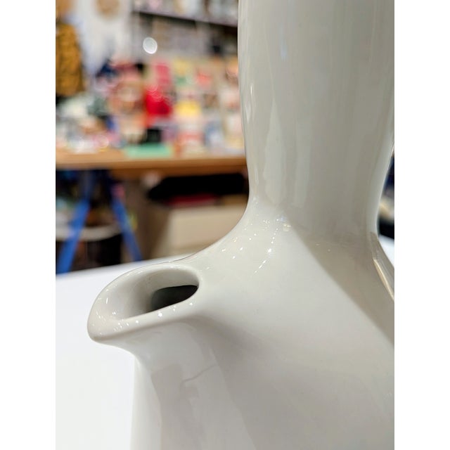Iconic American Modern pitcher by Russel Wright, produced by Steubenville Pottery. Sculptural ceramic form in white satin...