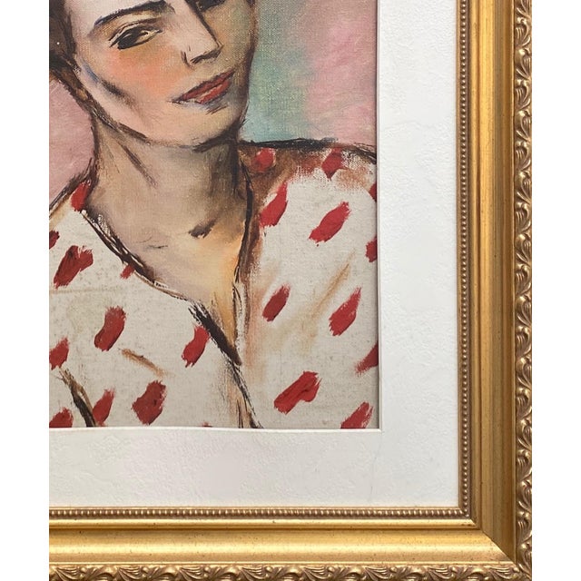 Oil painting on canvas board of a young woman in a print blouse. Palette of light pink, green cream, and red in gold leaf...