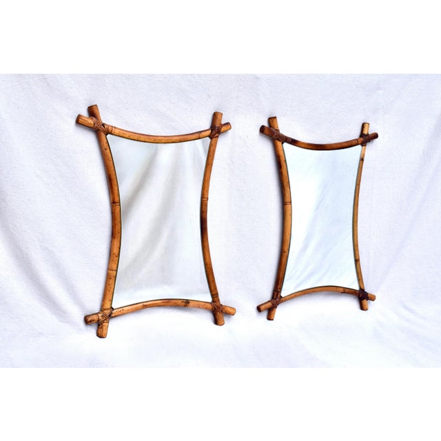 A pair of mid 20th Century Bamboo frame custom wall mirrors with warm golden patina ready for use.
