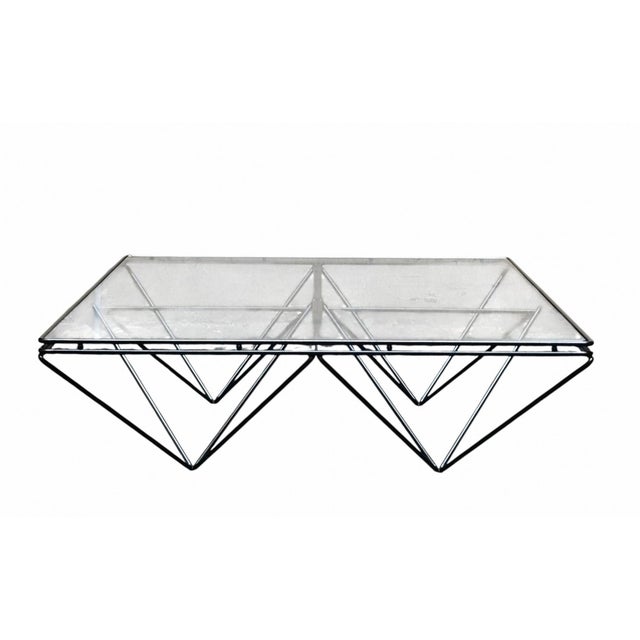Coffee table designed by Paolo Piva for B&B Italia, featuring a black painted metal rod frame and a transparent glass top....