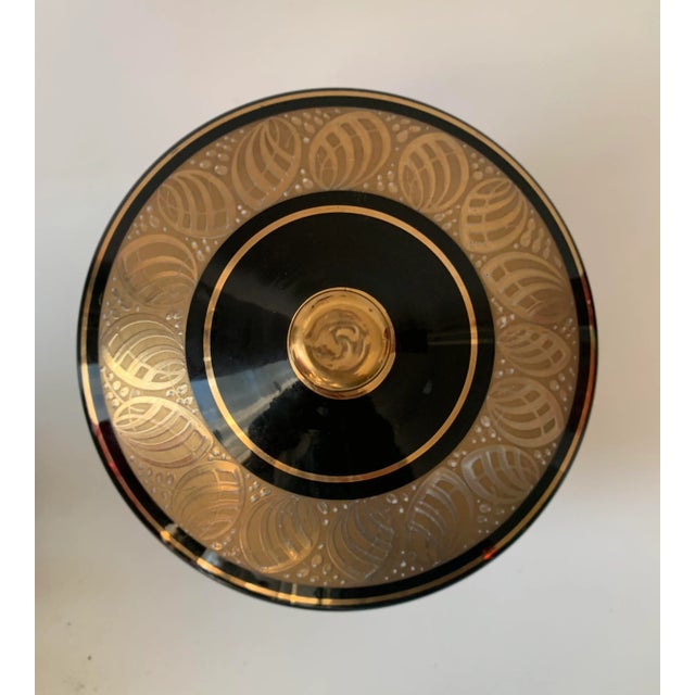 What a beautiful vintage Art Deco covered dish! Decorated with encrastation Gold leaf design on top and stripes on the...