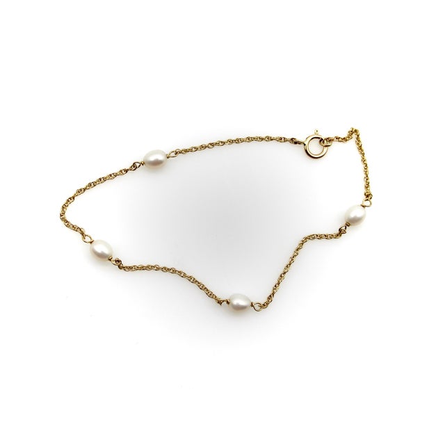 This sweet, dainty bracelet has sections of chain with a hand-wired pearl alternating between each section. The sections...