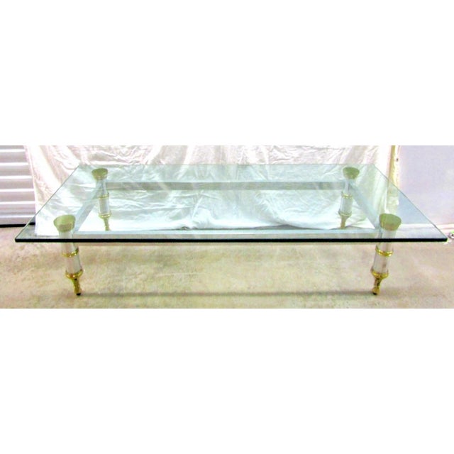 1960's Maison Jansen 78" Aluminum with Brass Accent Thick Glass Cocktail Table Overall measures 78" long, 30" wide and 16"...