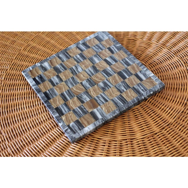 A very unique stone chess board or display board. Has a mosaic stone checkerboard design in an ochre brown and gray...