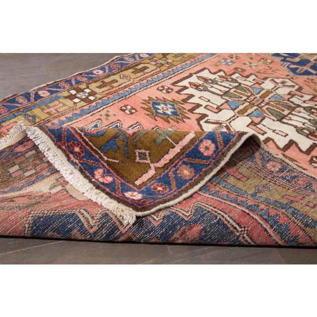 This beautiful Hamadan Hand-knotted wool rug has a peach field with blue accents allover the tribal design. This rug...