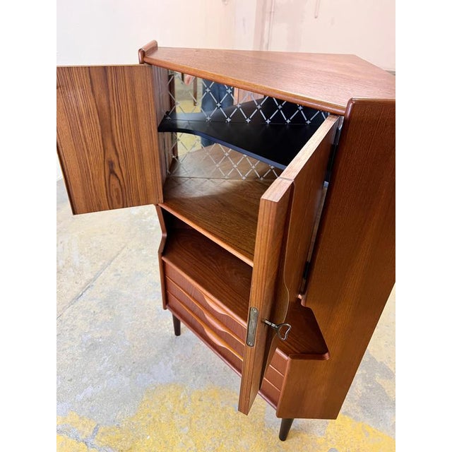 This Danish teak corner cabinet is the perfect combination of space-saving functionality and the glamorous lifestyle of...