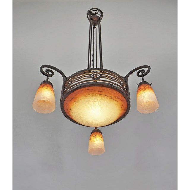 H. Fournet & Schneider A beautiful French 1925-1930 art deco chandelier in wrought iron and glass paste shades in mottled...