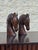 A handsome pair of vintage carved wooden horse head sculptures featuring expressive profiles, finely detailed manes, and...