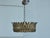 A Spanish gilt metal crown chandelier from the Midcentury period, with elongated leaves and frosted glass bottom. Created...
