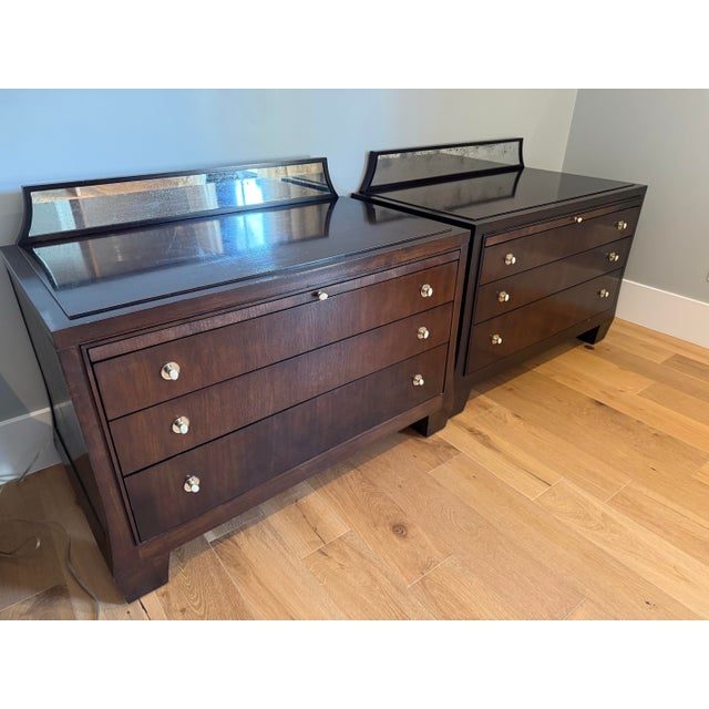 Known for their Modern Regency style, these chests feature a rich mahogany finish and a distinctive faux antiqued mirrored...