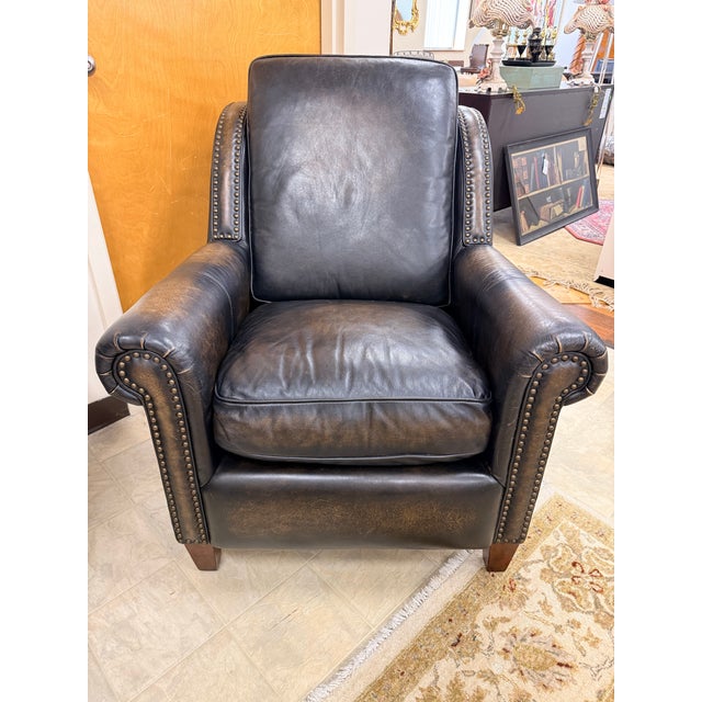 Handsome Thomasville leather club chair and matching ottoman in a rich, near-black distressed leather with warm tobacco...