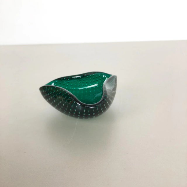 Murano glass bowl, ashtray element Origin: Murano, Italy Decade: 1970s This original glass shell bowl was produced in the...