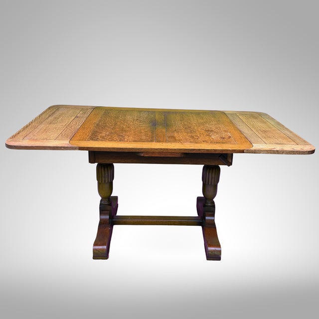 A richly figured oak draw-leaf pub table in English Jacobean Revival-Style, likely English and dating approximately to the...