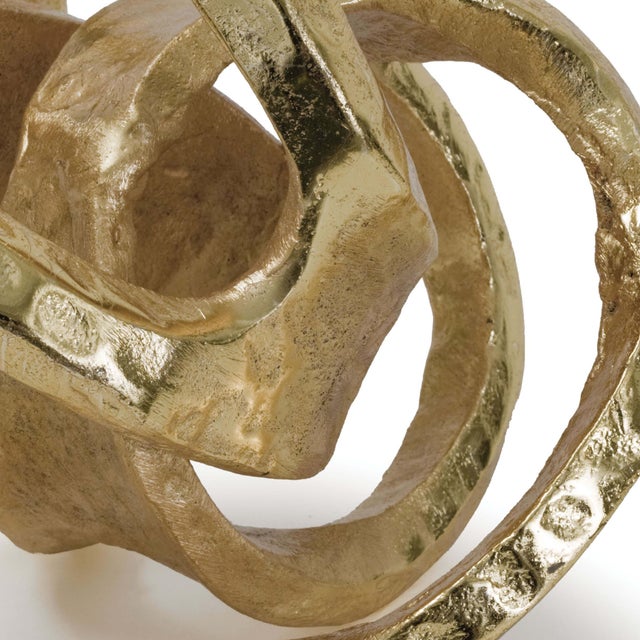 This abstract sculptural object wears a gold finish and has a real, handmade quality, perfect to dress up a living room...