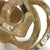 This abstract sculptural object wears a gold finish and has a real, handmade quality, perfect to dress up a living room...