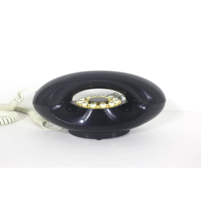 Vintage 1980’s Navy blue and gold genie phone with a white cord and push buttons. Good vintage condition. Rubber feet may...
