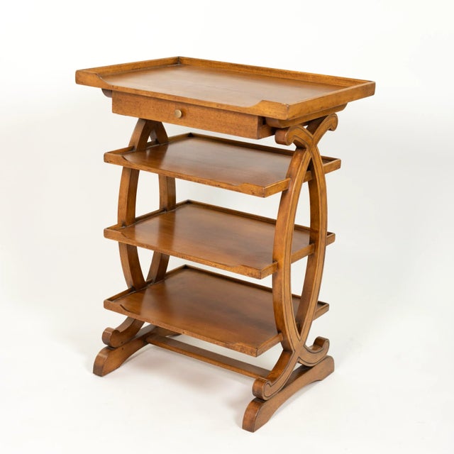 A small-scale French fruitwood étagère with four tiers and a single narrow drawer under the top shelf. A raised three-...