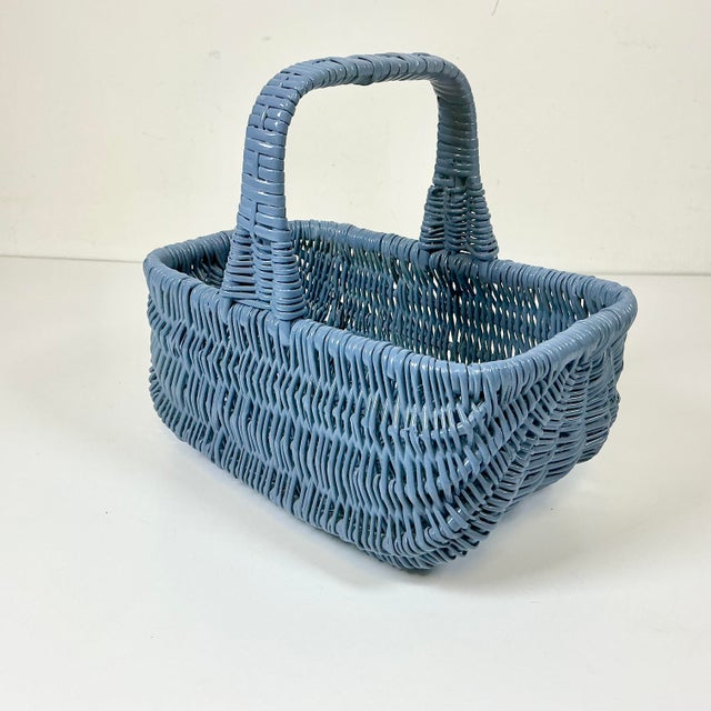 This is a pretty tabletop sized storage basket with a handle. It was curated along with a wicker wastebasket and we...