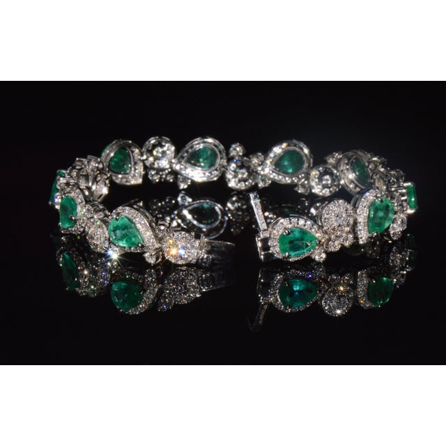 Exceptional solid 18K white gold natural emerald and diamond bracelet featuring 10 vibrant pear-shaped natural emeralds...