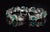 Exceptional solid 18K white gold natural emerald and diamond bracelet featuring 10 vibrant pear-shaped natural emeralds...
